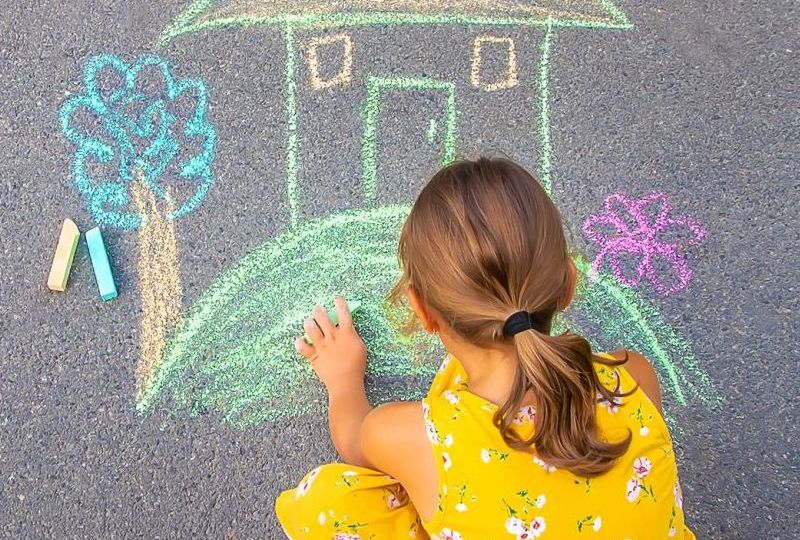 The,Child,Draws,A,House,On,The,Asphalt.,Selective,Focus.