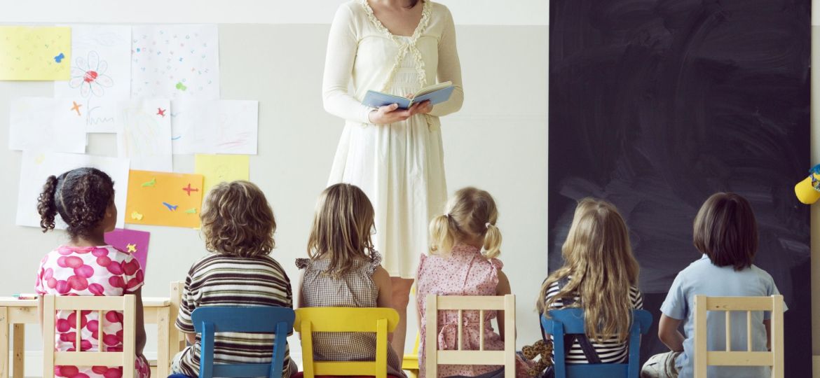 Preschool teacher reading to students