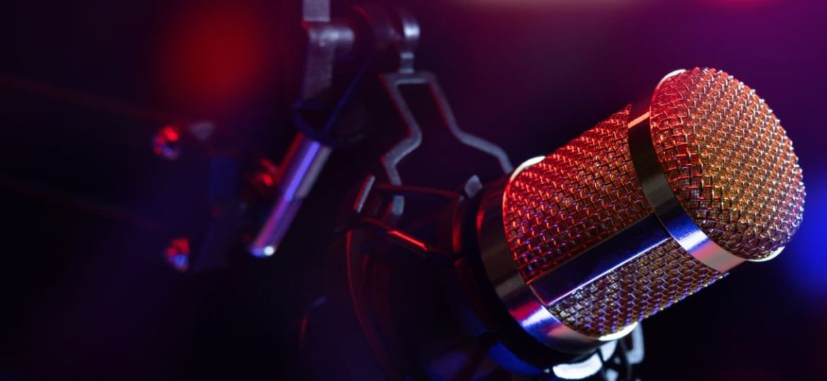 studio microphone in neon lights. sound recording equipment